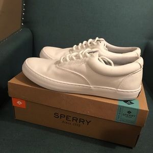 Pair of white Sperry  shoes .